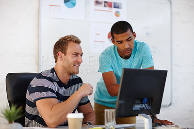 Buy stock photo Shot of two male designers working at a computer
