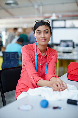 Buy stock photo Portrait of a female designer with measuring tape around her neck sitting at her desk