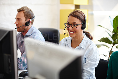 Buy stock photo Shot of customer service representatives taking calls in their office