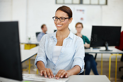 Buy stock photo Shot of a young female designer working on her office computer