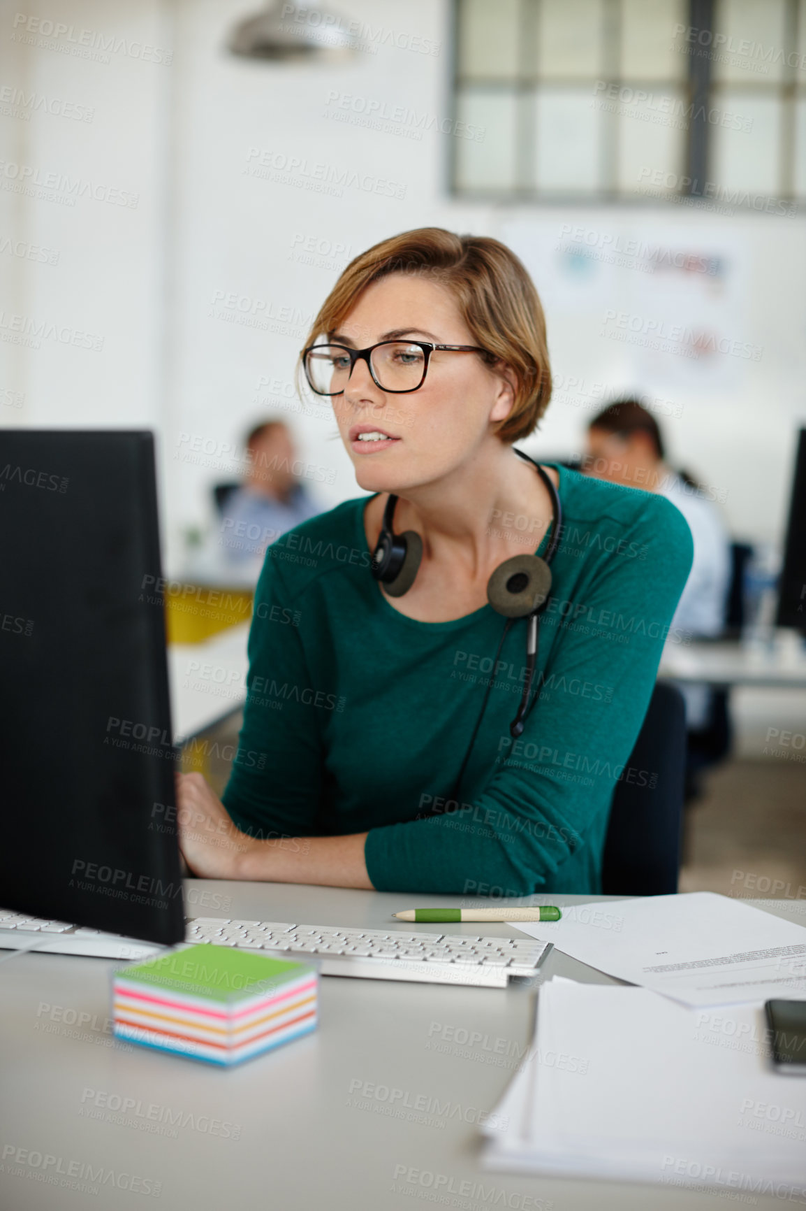 Buy stock photo Shot of a beautiful woman wearing a headset while working at her desk in the office