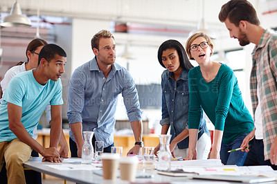 Buy stock photo Shot of a group of young designers having a brainstorming meeting