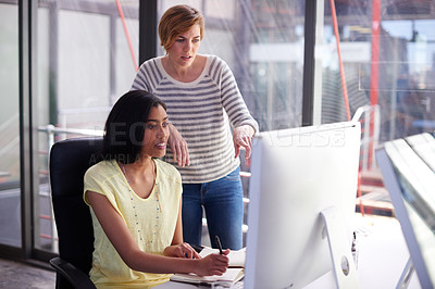 Buy stock photo Portrait of two colleagues working together on a computer