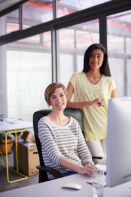 Buy stock photo Portrait of two colleagues working together at a desk
