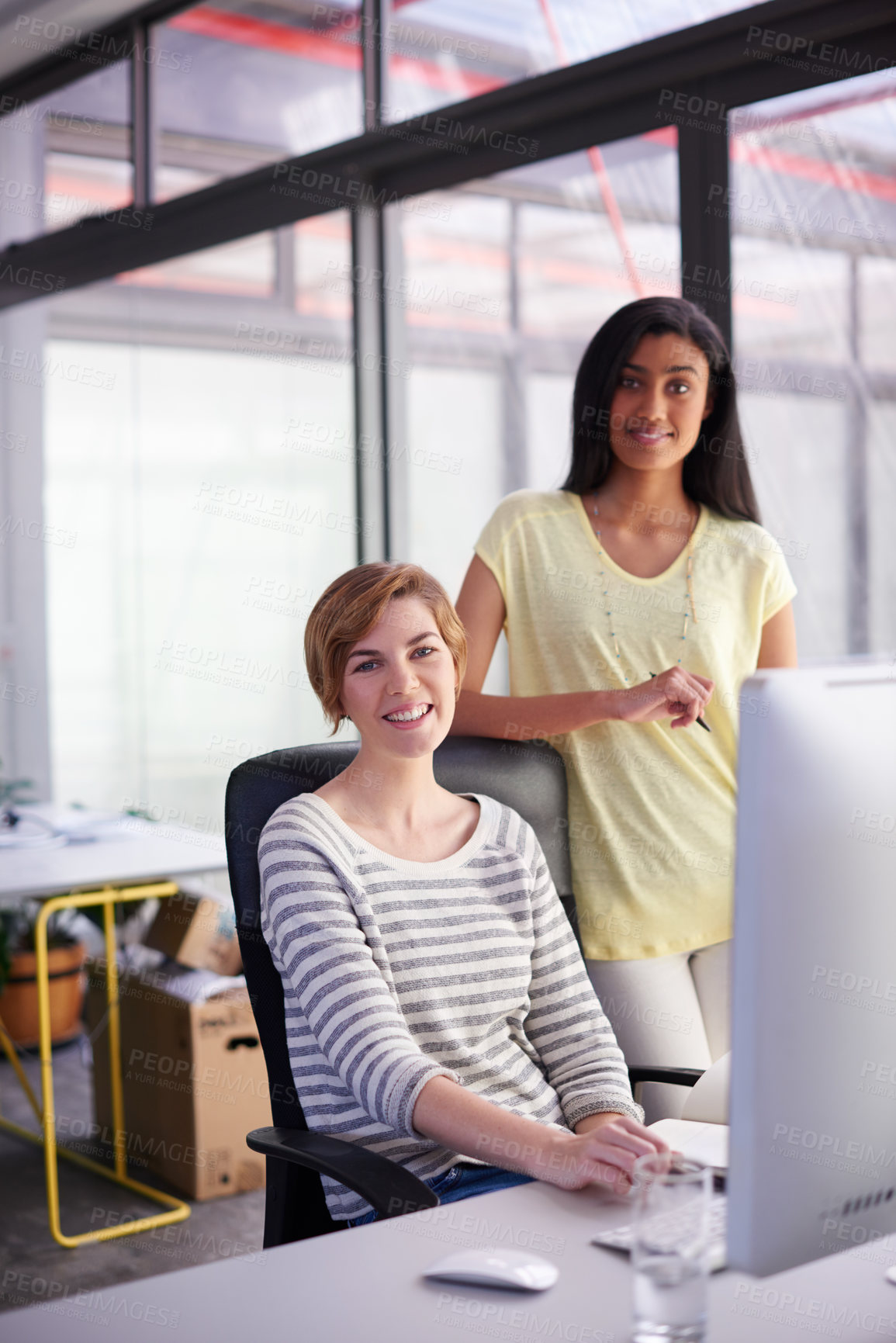 Buy stock photo Portrait of two colleagues working together at a desk