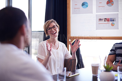 Buy stock photo A young woman taking the lead in a meeting with colleagues