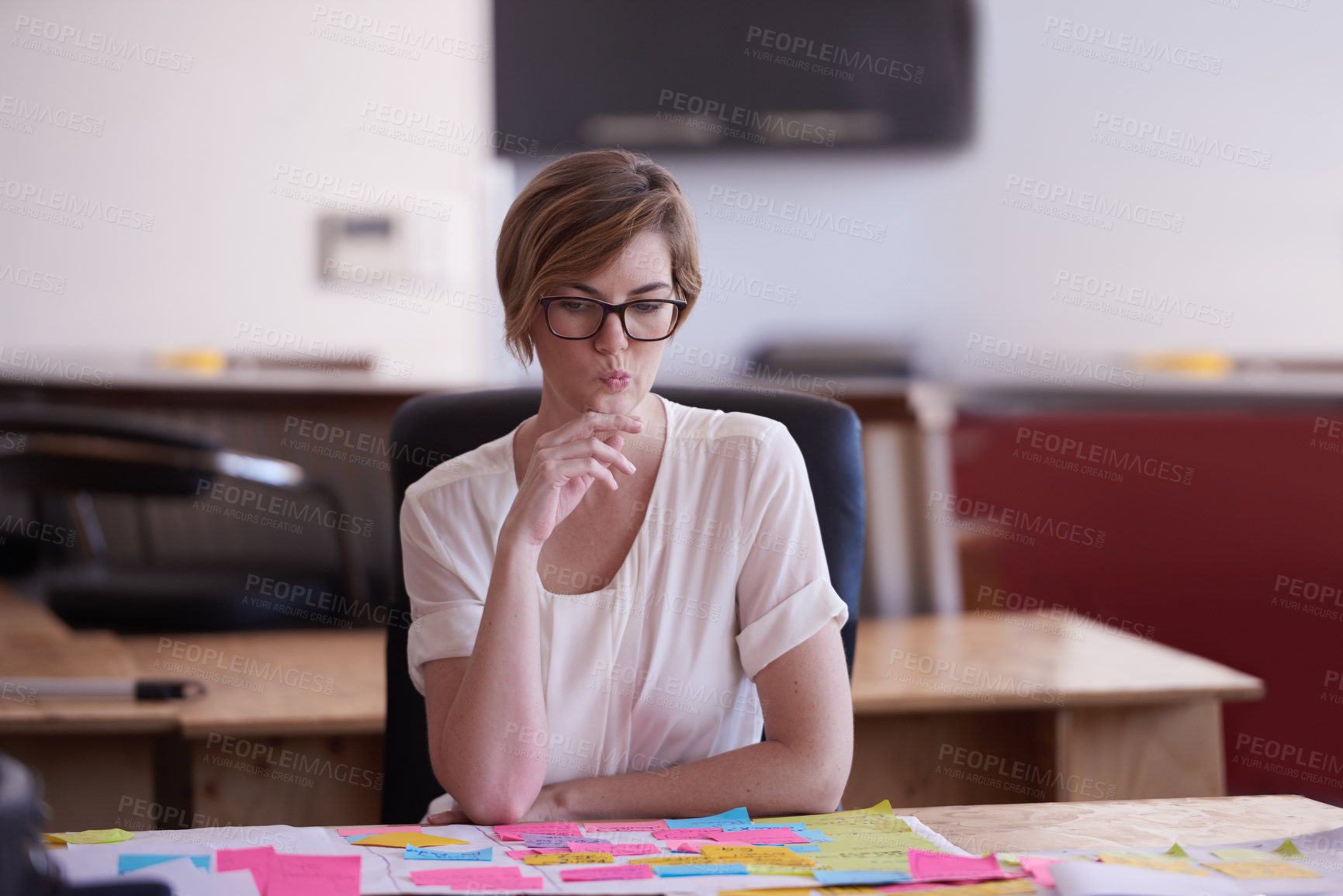 Buy stock photo Woman, planning and thinking with notes at startup with project, decision and insight at media company. Person, editor and confused with documents for mind map, process and review at creative agency