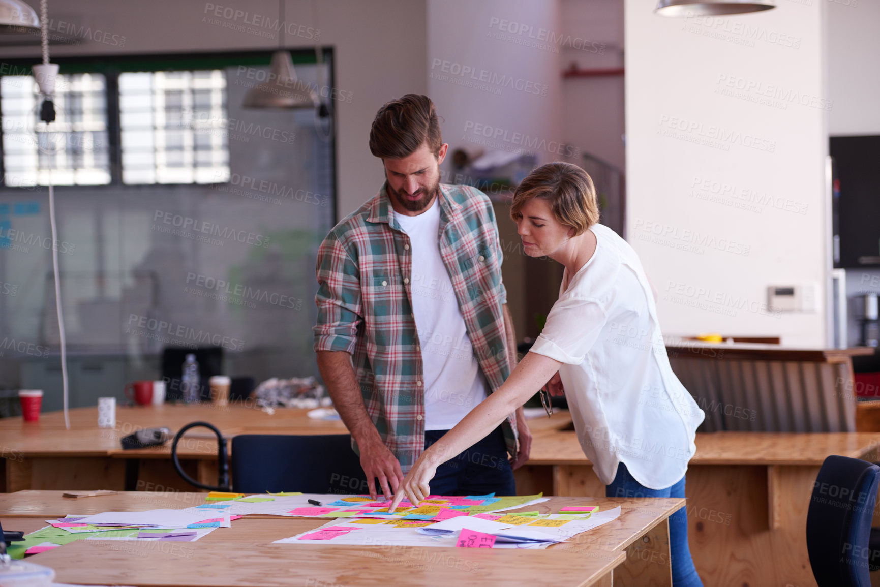 Buy stock photo Woman, man and discussion with notes at startup for project, point or problem solving at media company. People, teamwork and reading with documents for mind map, process and review at creative agency