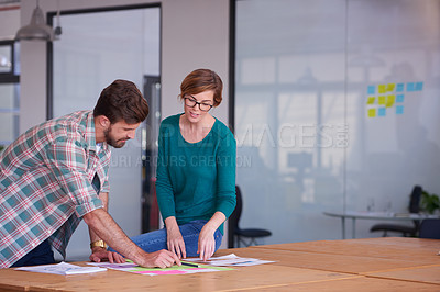 Buy stock photo Shot of a group of young creatives talking around a table