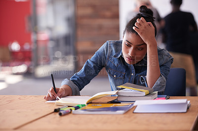 Buy stock photo A young creative professional looking tired at her desk