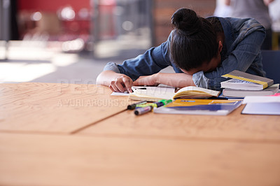 Buy stock photo A young creative professional looking tired at her desk