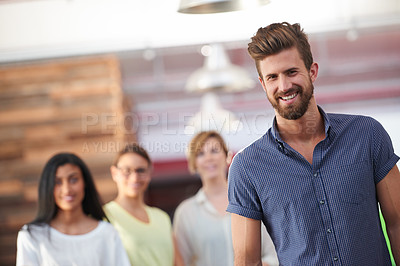 Buy stock photo Portrait of a confident man standing in front of his team in a casual working environment