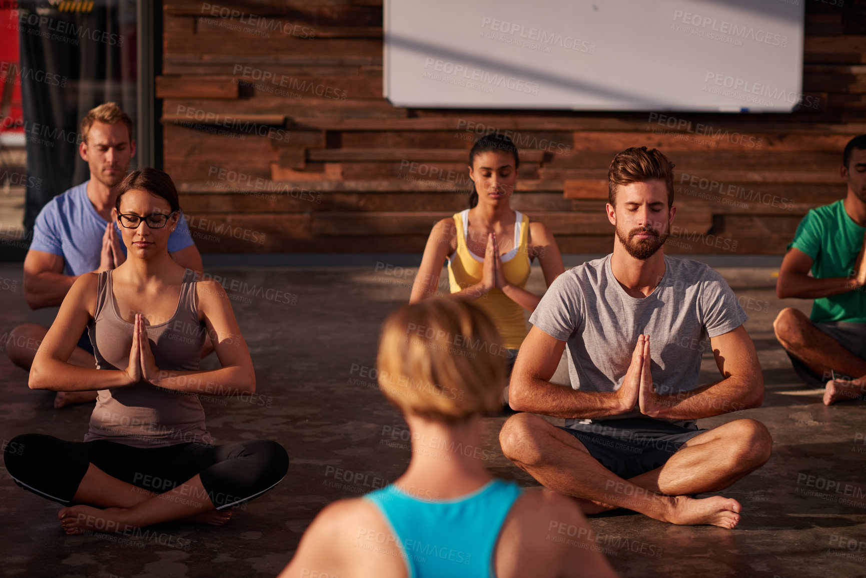 Buy stock photo Prayer hands, meditation or instructor with people in yoga class for chakra energy, therapy and inner peace. Group, wellness and zen yogi in studio for spiritual healing, breathe or calm mindfulness