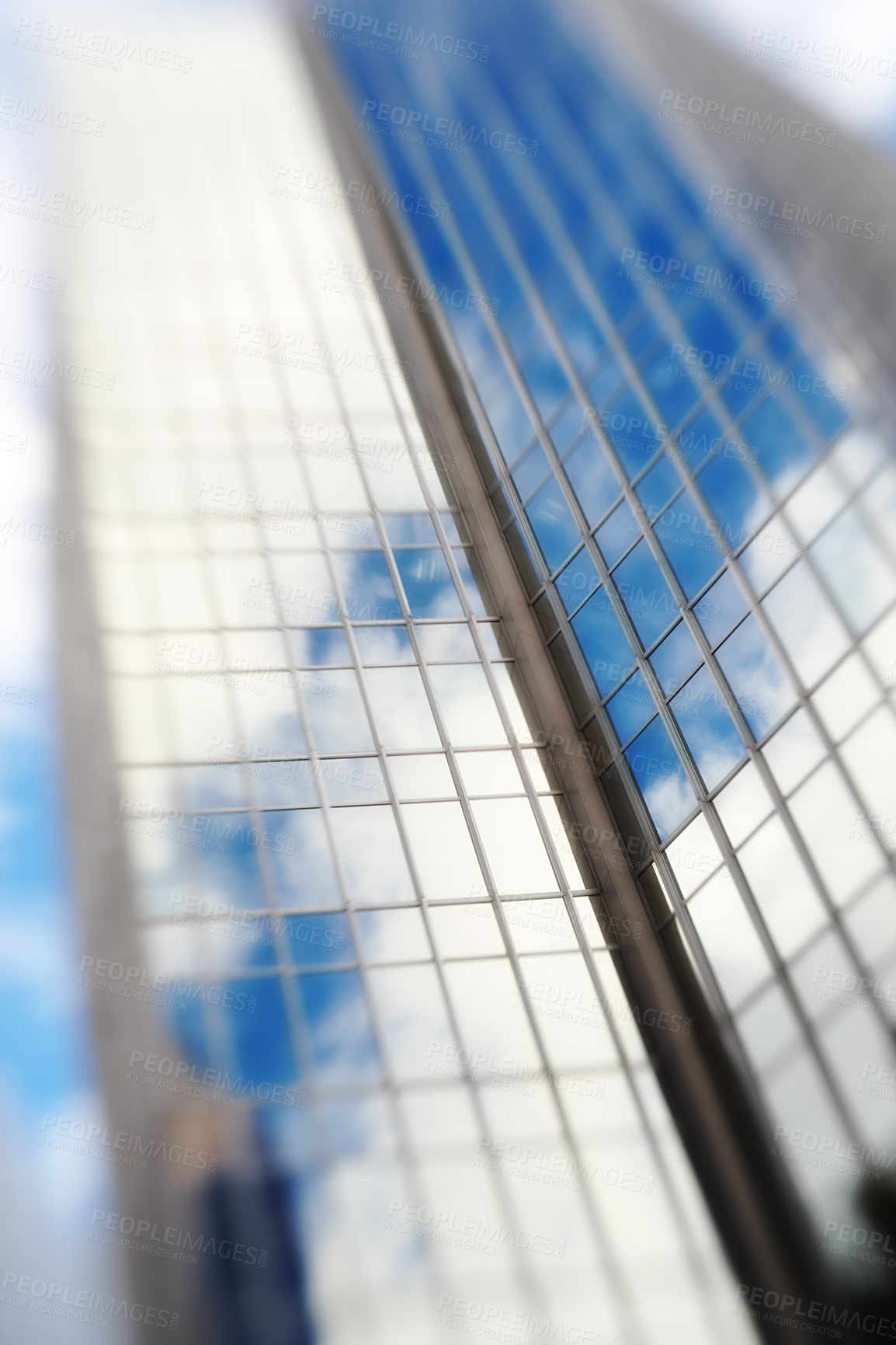 Buy stock photo Blurry, building and window of skyscraper in city with reflection of blue sky and clouds on glass. Urban, office and architecture of tower or hotel with trippy motion for vertigo from heights in town