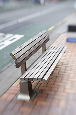 Buy stock photo Urban, bench and seat on sidewalk in city with blurry motion for vertigo or trippy dizziness. Wood, chair and sit on street with support of government infrastructure, development or town progress