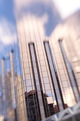 Buy stock photo Blurry, skyscraper and window of building in city with reflection of blue sky and clouds on glass. Urban, office and architecture of tower or hotel with trippy motion for vertigo from heights in town