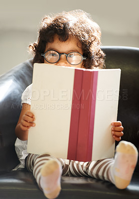 Buy stock photo Child, portrait or glasses book read for fun education, learning or childhood development knowledge. Little girl, face on sofa for notebook studying or dress up as professional, school work or play