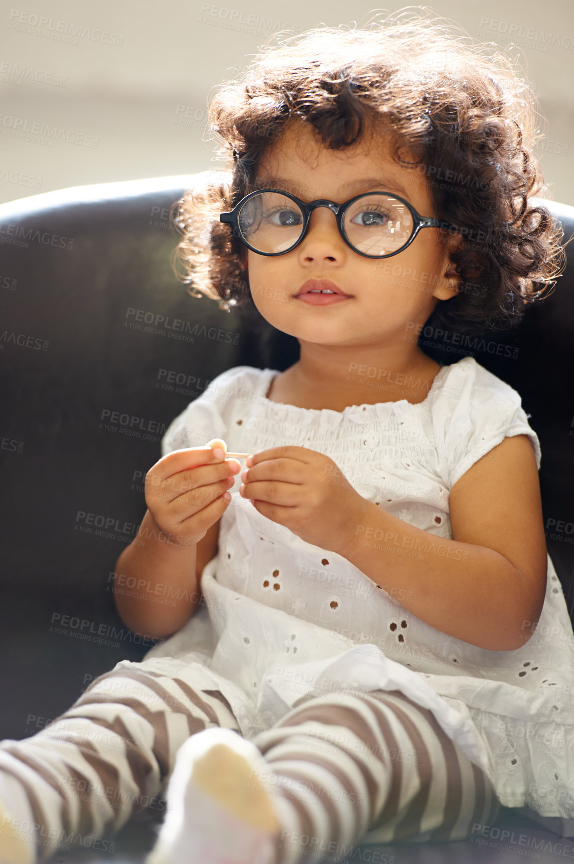 Buy stock photo Girl, child and portrait or glasses for play, learning development or education growth. Female person, toddler and face eyewear on sofa in home for comedy outfit as professional, intelligence or fun