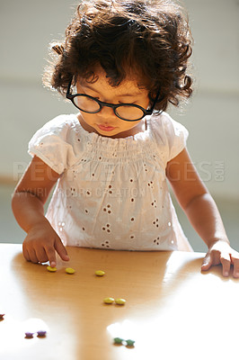 Buy stock photo A little girl counting her candy