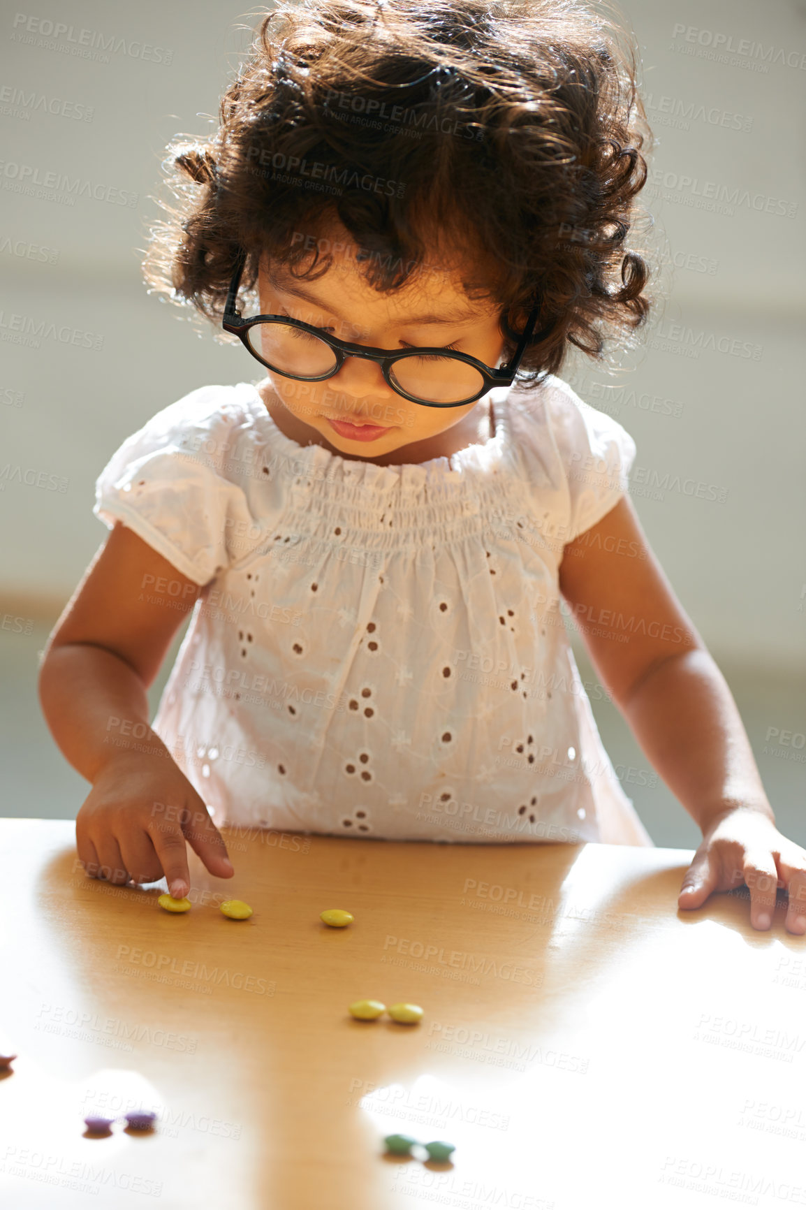 Buy stock photo A little girl counting her candy