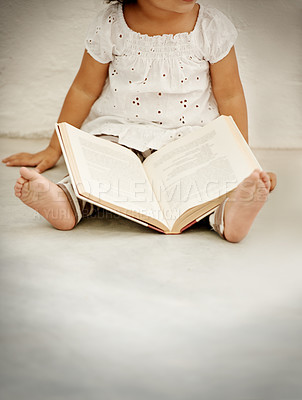 Buy stock photo A little girl reading a book