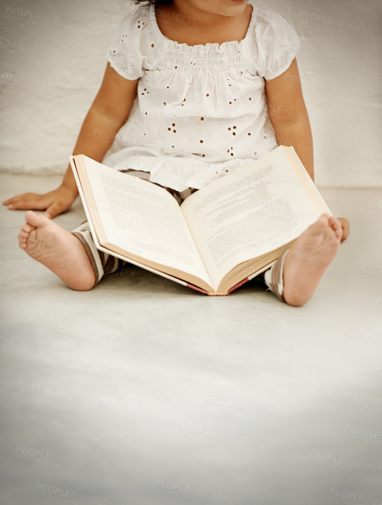Buy stock photo A little girl reading a book