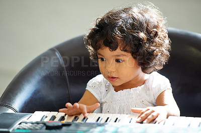 Buy stock photo Girl, child and keyboard music play for childhood learning, education development or lessons. Female person, kid and piano keys song or instrument training knowledge, youth artist or future musician