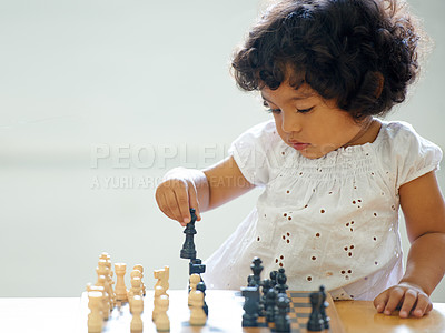 Buy stock photo Toddler, girl and chess play for learning growth, childhood development or thinking challenge. Female person, board game or table problem solving intelligence or kids, planning knowledge or education