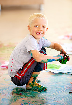 Buy stock photo Portrait, smile and boy painting the floor in a studio for art education at school as a creative student. Kids, growth and kindergarten with a happy young child learning how to paint in a classroom