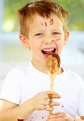 Buy stock photo Boy, chocolate or spoon in messy, baking or playful activity as meal prep, growth or milestone. Naughty male child, eating or smile at food, mixture or ingredients as learning nutrition in kitchen
