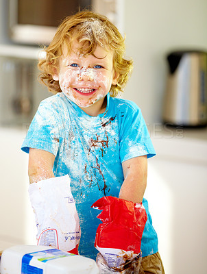 Buy stock photo Messy, boy or flour to play, baking or fun holiday activity as meal prep, nutrition or portrait. Naughty, male child or ingredients on counter in happy, excited or cooking at weekend in kitchen