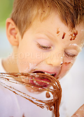 Buy stock photo Closeup, messy or boy eating chocolate or baking as fun, meal prep or holiday activity in home. Naughty, male child or whip to lick, dessert or food mixture by learning, nutrition or wellness