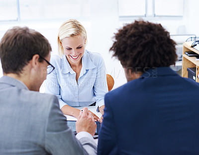 Buy stock photo Shot of a confidently businesswoman in a meeting with two male colleagues