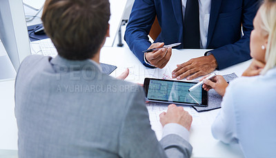 Buy stock photo Shot of businesspeople discussing plans on a digital tablet
