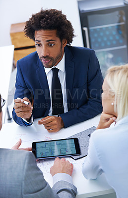 Buy stock photo Shot of a businessman involved in a discussion with staff members