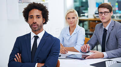 Buy stock photo Portrait of a serious businessman with his colleagues in the background