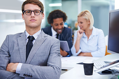 Buy stock photo Portrait of a serious businessman with staff in the background