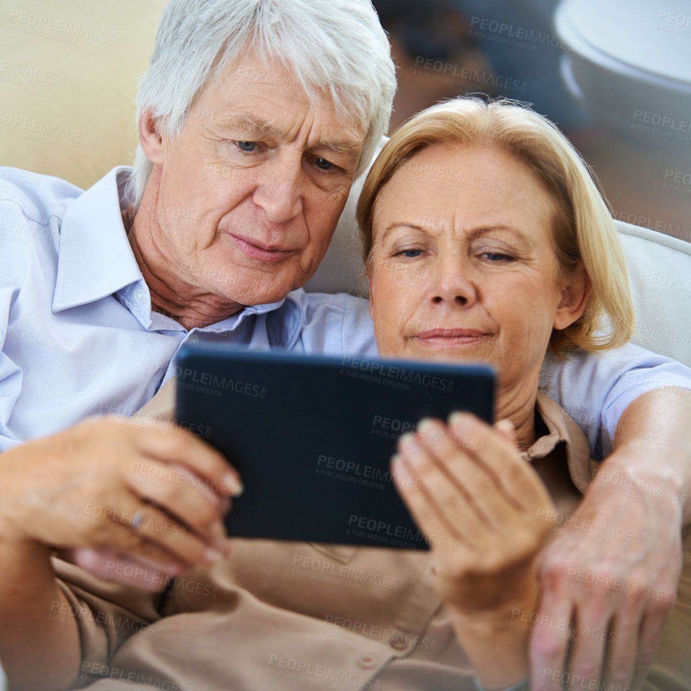 Buy stock photo Home, tablet and old couple with online reading, internet or retirement with comfort, digital app and relax. Network, senior man or mature woman with tech, communication or discussion with comfort