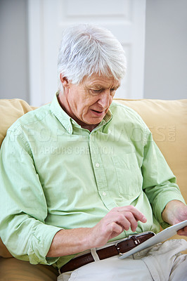 Buy stock photo Tablet, home and elderly man on sofa on internet for social media, website and online chat. Retirement, relax and senior person on digital tech for search, reading news and connection in living room