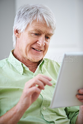 Buy stock photo Tablet, happy and senior man in home on internet for social media, website and online entertainment. Retirement, relax and elderly person on digital tech for crossword, reading news and puzzle