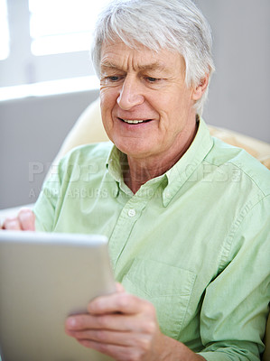 Buy stock photo Tablet, relax and senior man in home on internet for social media, website and online entertainment. Retirement, happy and elderly person on digital tech for search, reading news and connection