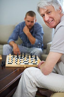 Buy stock photo Elderly dad, portrait or playing chess in home for games or contest for strategy or problem solving. Senior parent, happy or board for challenge or thinking of mental skills for cognitive function