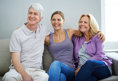 Buy stock photo Shot of a happy elderly couple relaxing on the sofa together with their daughter at home