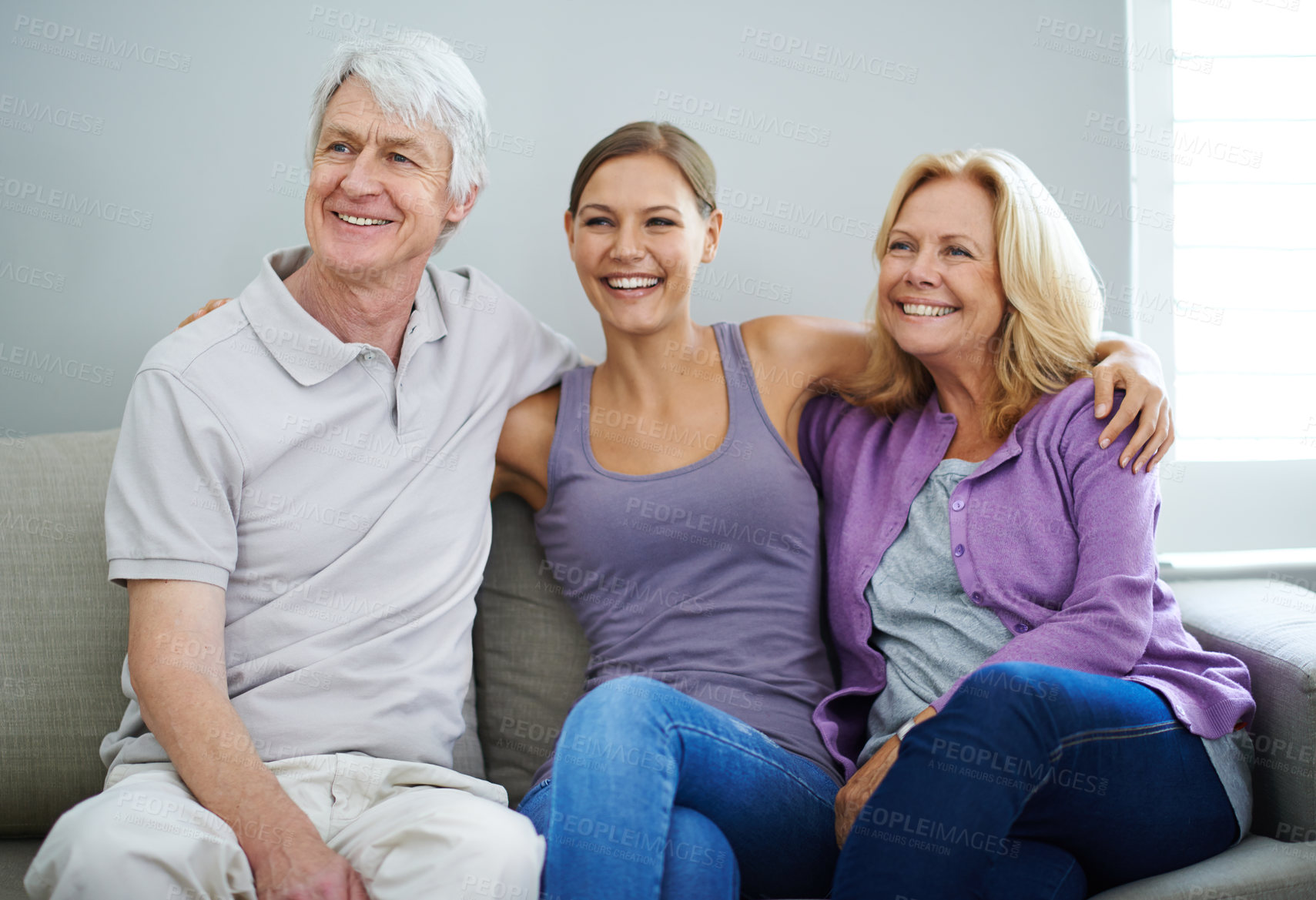 Buy stock photo Shot of a happy elderly couple relaxing on the sofa together with their daughter at home