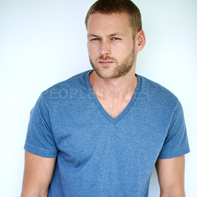 Buy stock photo Fashion, serious and portrait of man on blue background with trendy clothes, casual style or cool outfit. Aesthetic, stylish and isolated male person with confidence, pride and attitude in studio