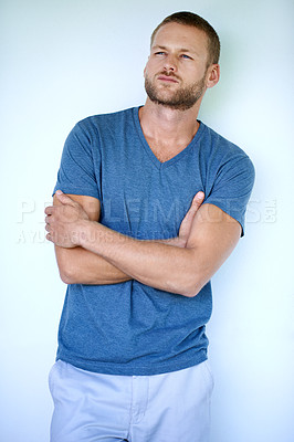 Buy stock photo Man, thinking and fashion in studio for confidence, style and aesthetic with trendy casual wear. Male person, cool and idea on white background for model, relaxed outfit and clothes with crossed arms