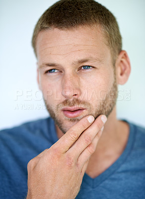 Buy stock photo Man, beard and thinking in studio with choice for grooming, skincare or cosmetics by white background. Person, model and ideas with touch for facial hair, decision and routine with hygiene in Germany