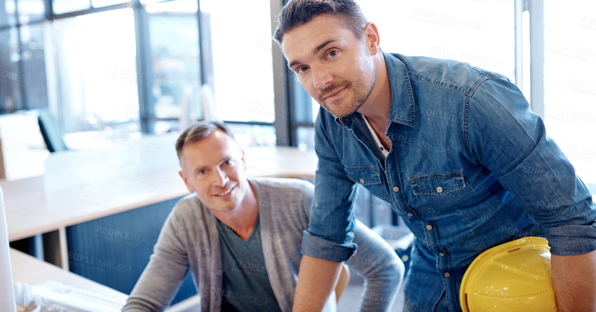 Buy stock photo Portrait of two handsome architects working together in their office