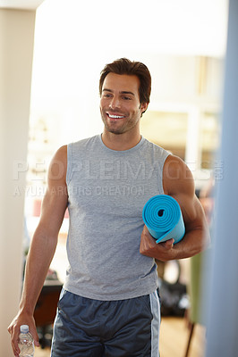 Buy stock photo Shot of a handsome young man in sports wear on his way to yoga