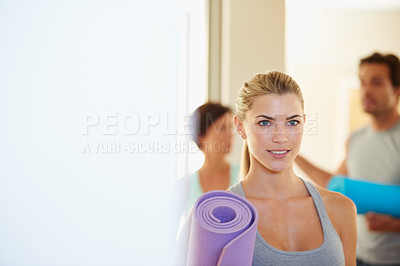 Buy stock photo Fitness woman after a yoga class holding her exercise mat. Sporty female ready for her workout at a fitness training centre. Active yogi ready for exercise and to enjoy sporty hobby at gym